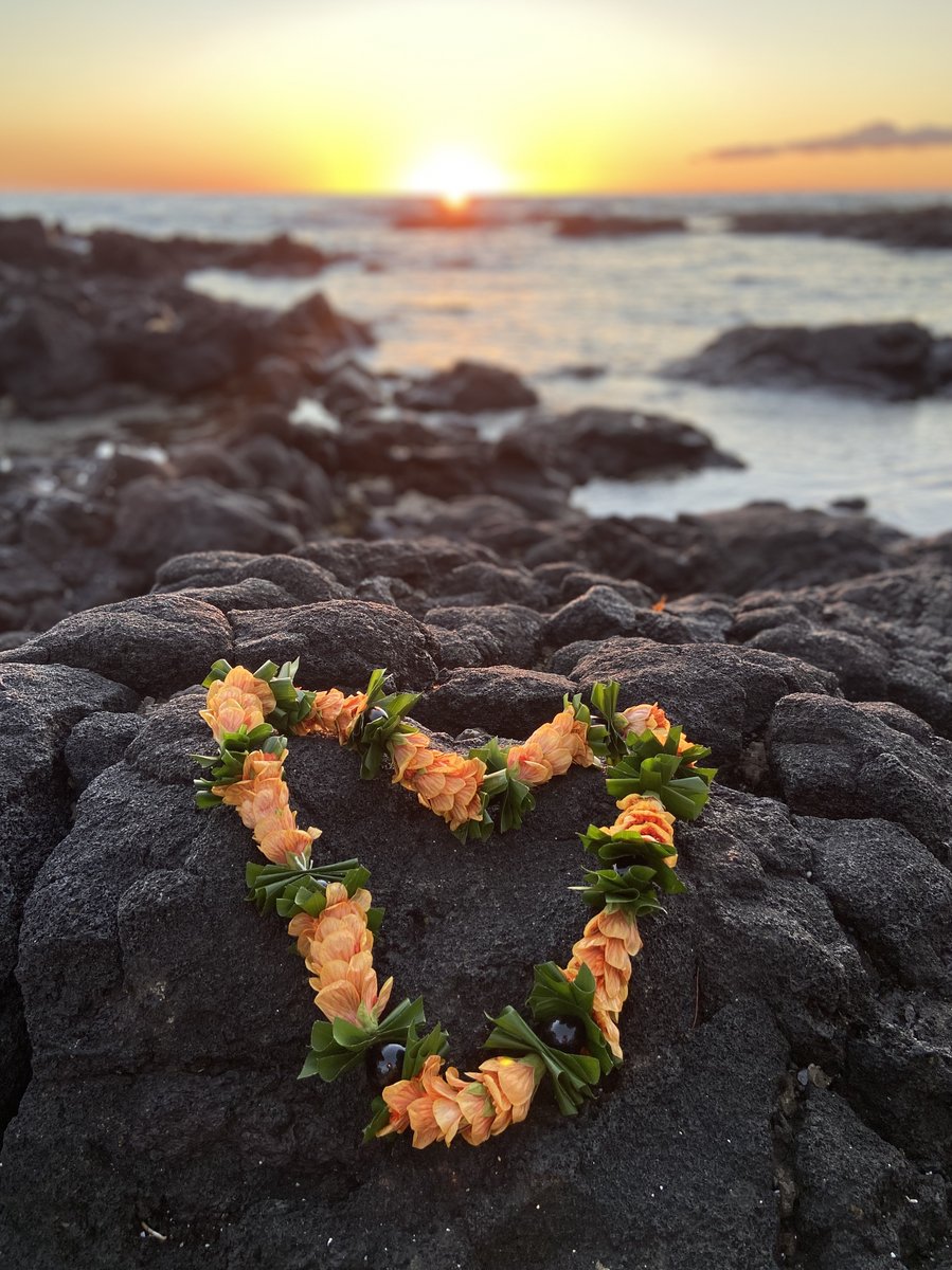 Lei heart on lava at sunset